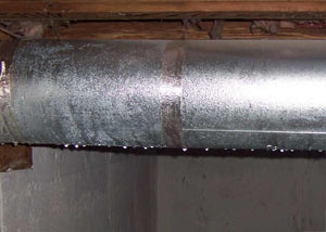condensation collecting on an HVAC vent in a humid Plymouth basement
