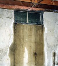 Flooding through basement windows in a Middlebury home.