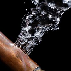 A bursting copper pipe in Mishawaka, with water gushing out.