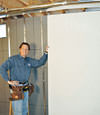 Installing wall panels on top of our basement wall insulation in La Porte