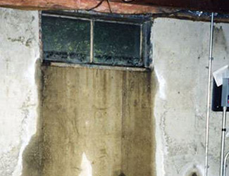 Water pouring out from a basement window in Goshen